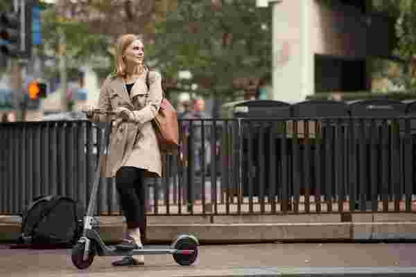 Young woman electric scooter city