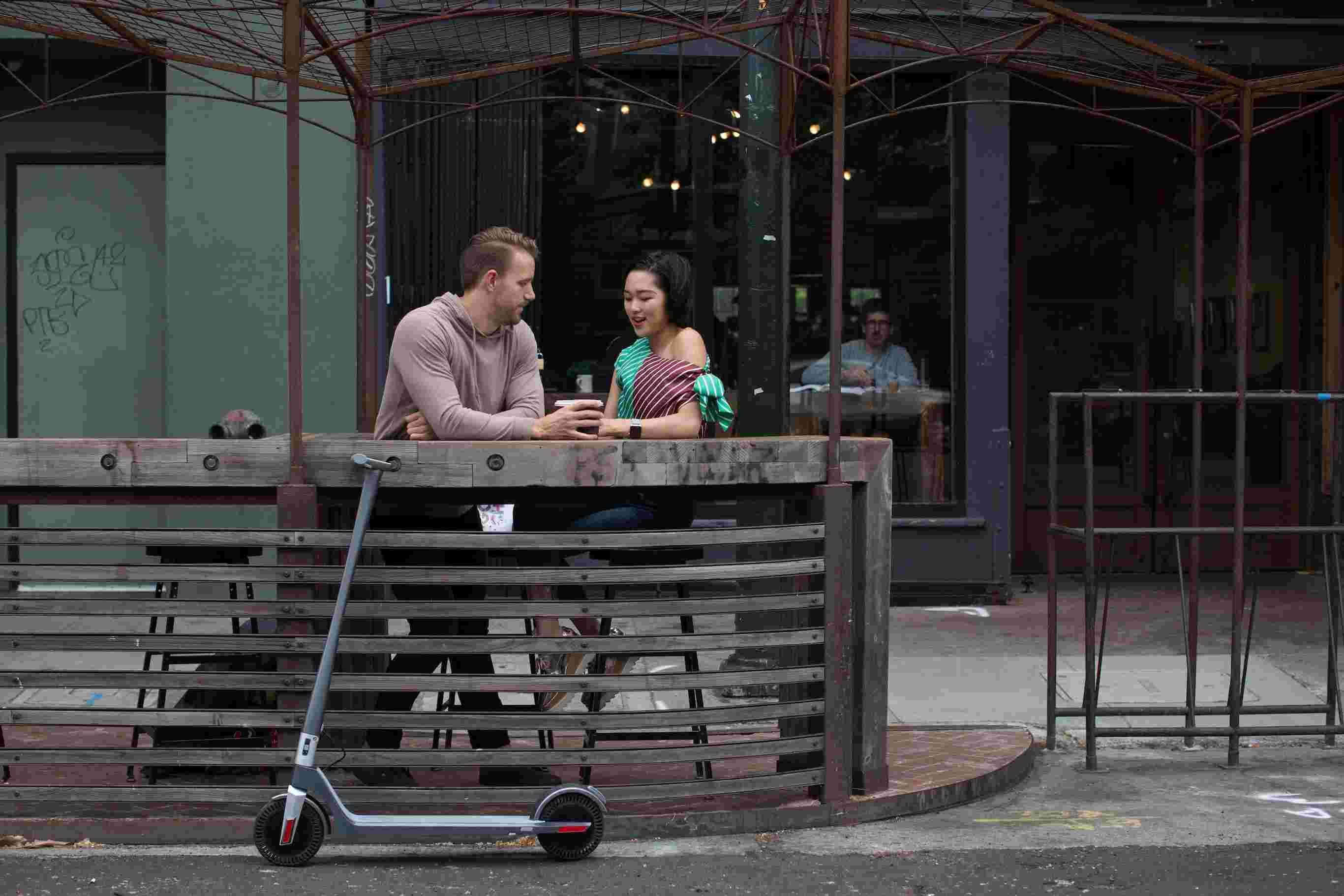 Electric Scooter Lifestyle Man Woman Talking Coffee