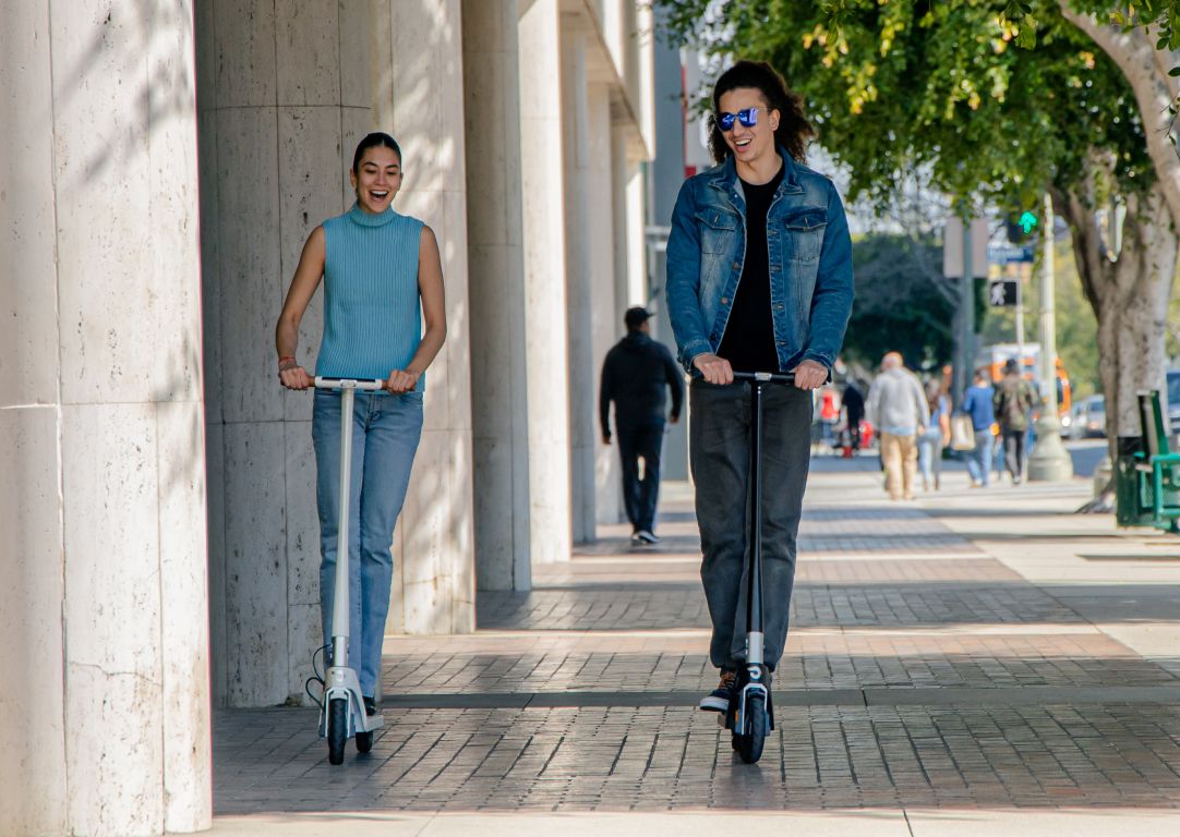 man and woman on scooters