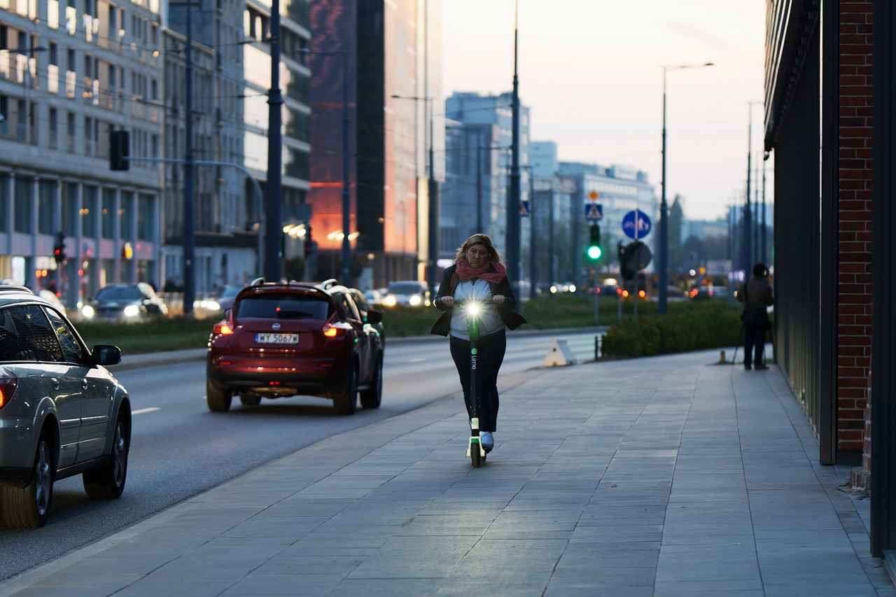 woman rides electric scooter