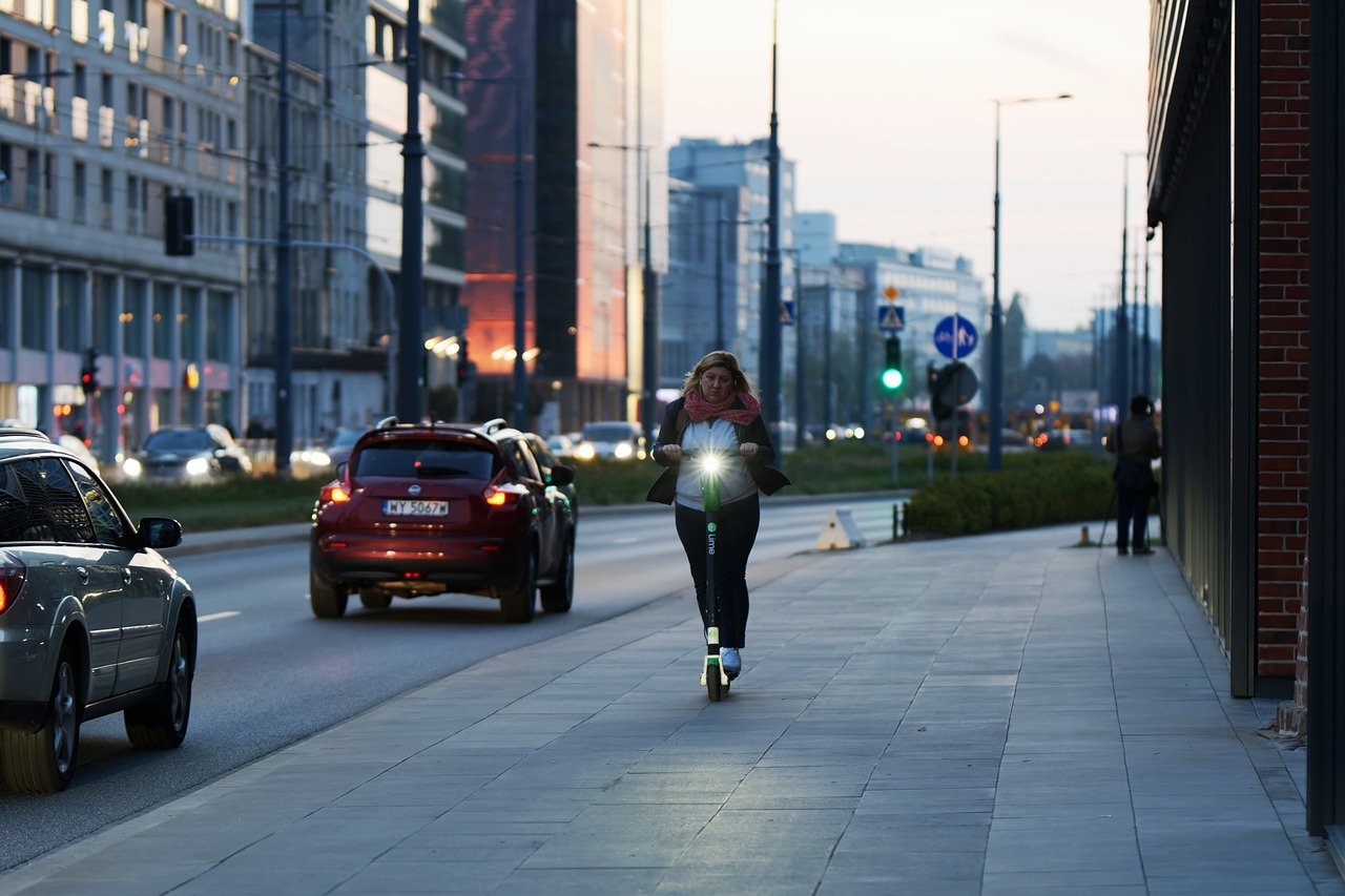 woman rides electric scooter