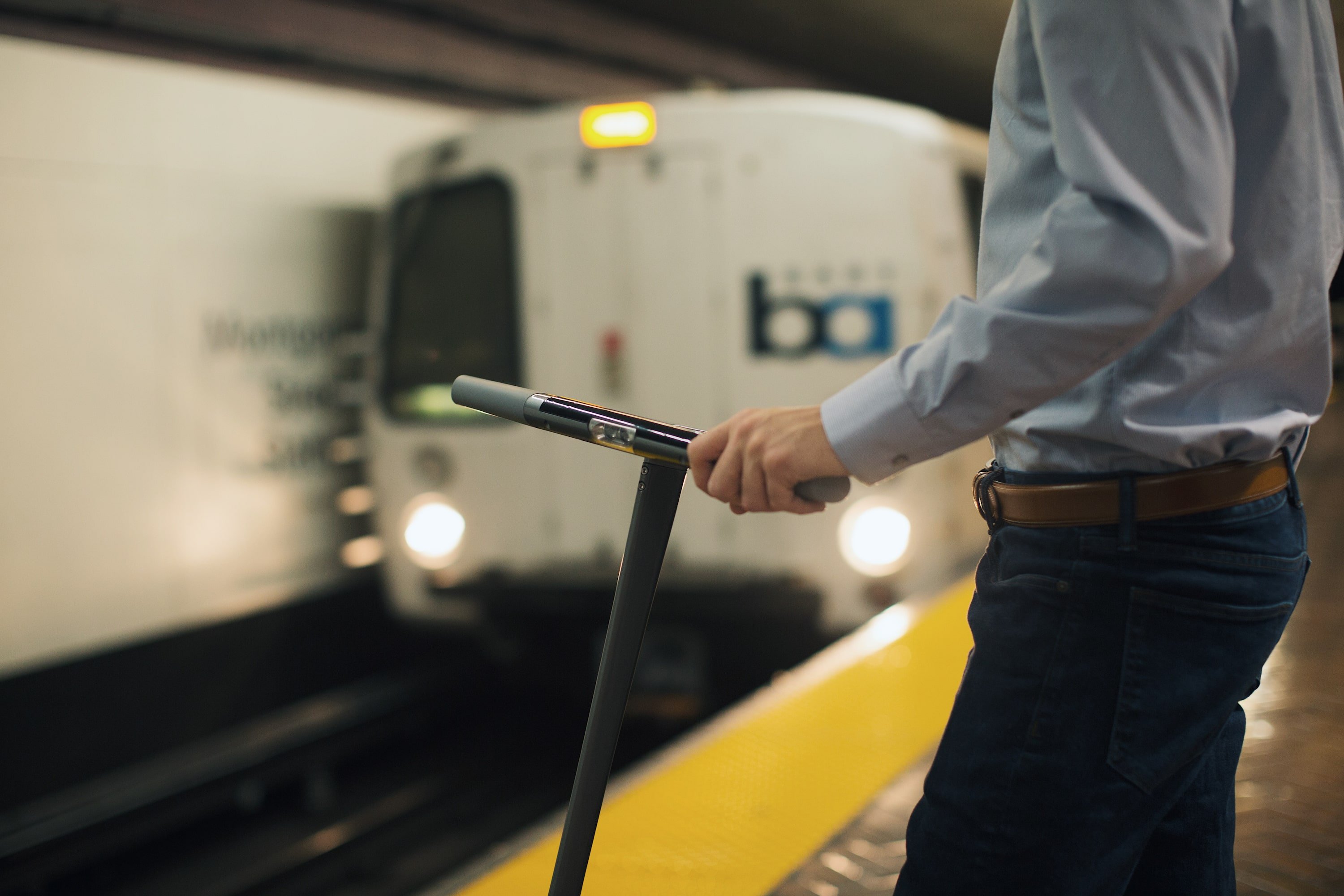 Man Riding Subway BART With Electric Scooter