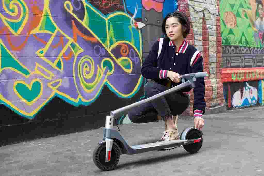 young asian woman folding scooter