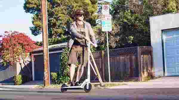 Man riding Unagi electric scooter