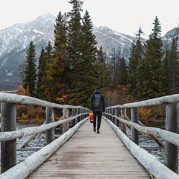 Rumpl Nanoloft Puffy Travel Size - Pyro Tri-Fade carrying wood bridge