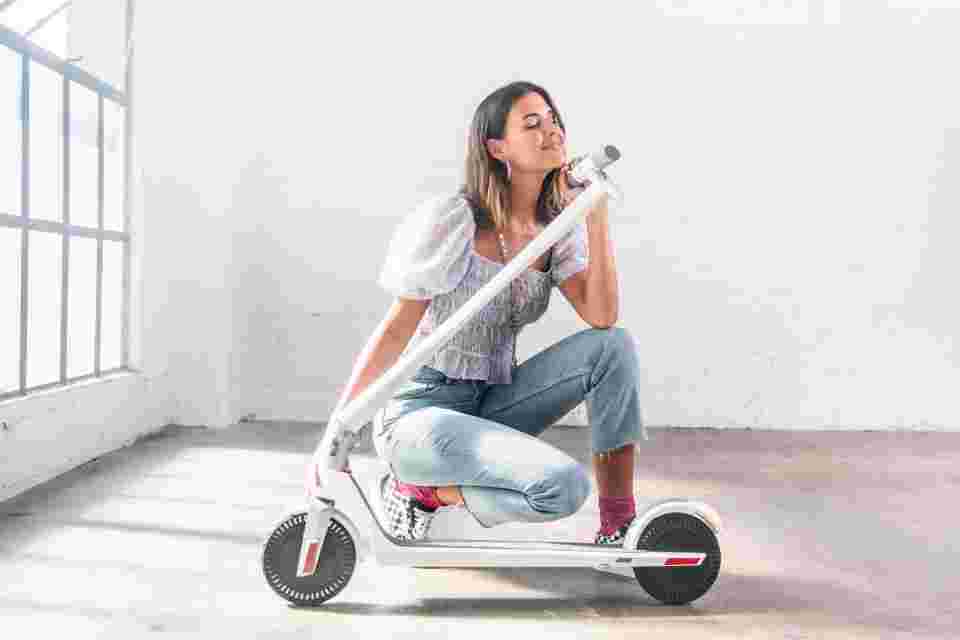 Unagi Adult Electric Scooter Woman Posing