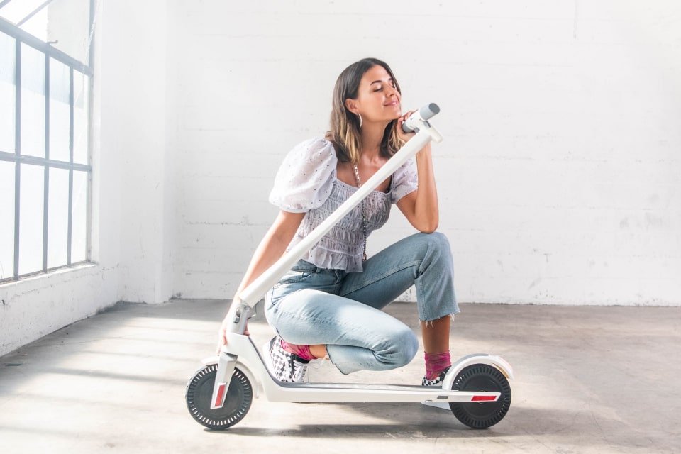 Unagi Adult Electric Scooter Woman Posing
