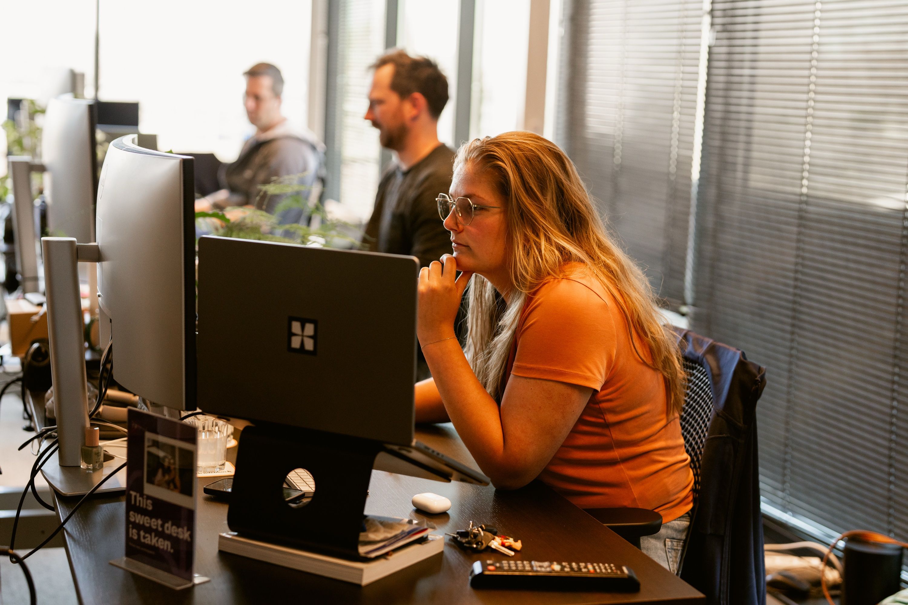 Working at a desk with several monitors in the Alkmaar office.