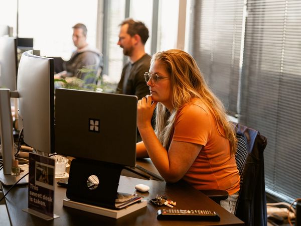 Working at a desk with several monitors in the Alkmaar office.