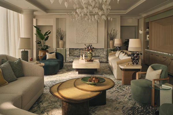 Elegant living room in a Westminster penthouse featuring layered seating in neutral and green tones, a sculptural leaf chandelier, marble fireplace, and textured rug with botanical motifs.