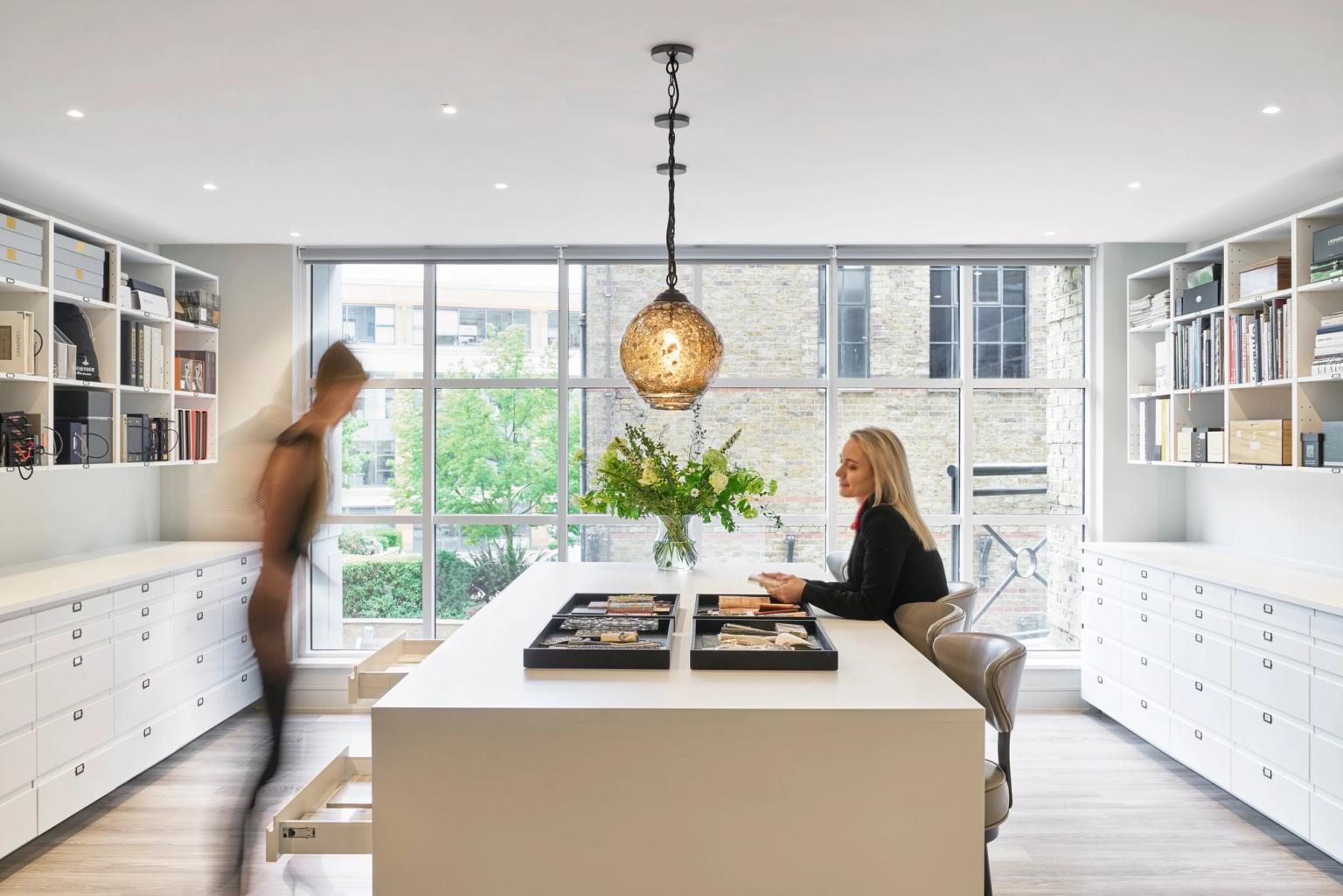The Elicyon meeting room with two of the designers discussing. 