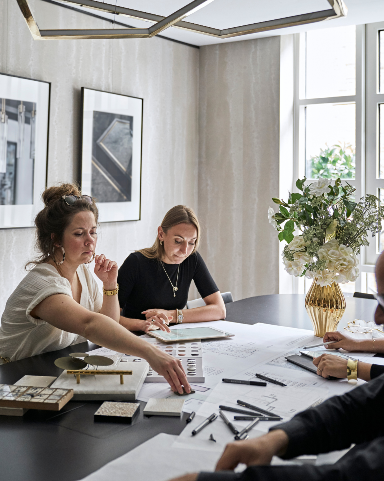 The Elicyon team in a design review session, assessing samples and drawings.