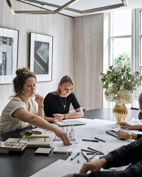 The Elicyon team in a design review session, assessing samples and drawings.