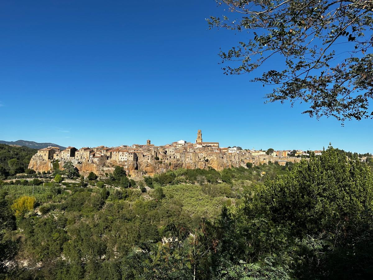 Pitigliano rising on its tuff cliff above the Maremma countryside — one of southern Tuscany's three tuff towns.