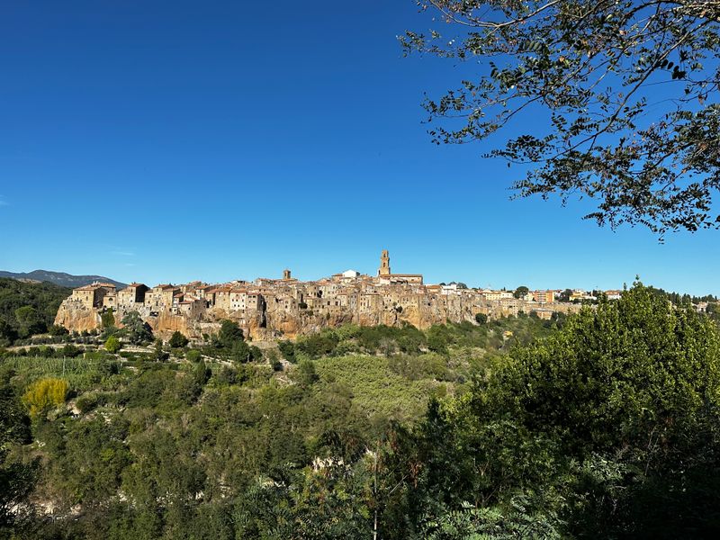 Pitigliano rising on its tuff cliff above the Maremma countryside — one of southern Tuscany's three tuff towns.