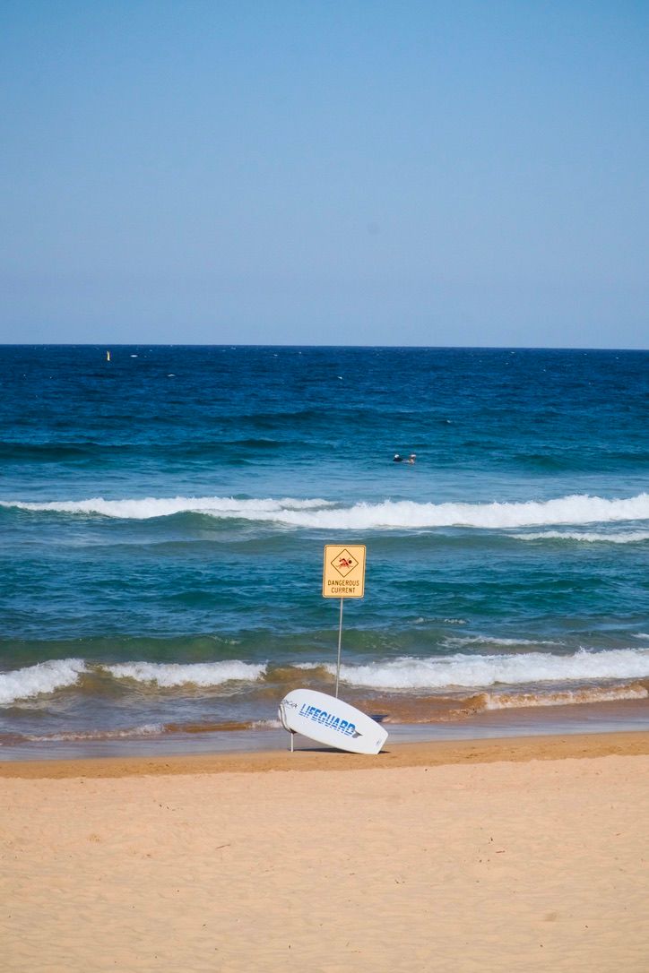 surfboard besides the warning board