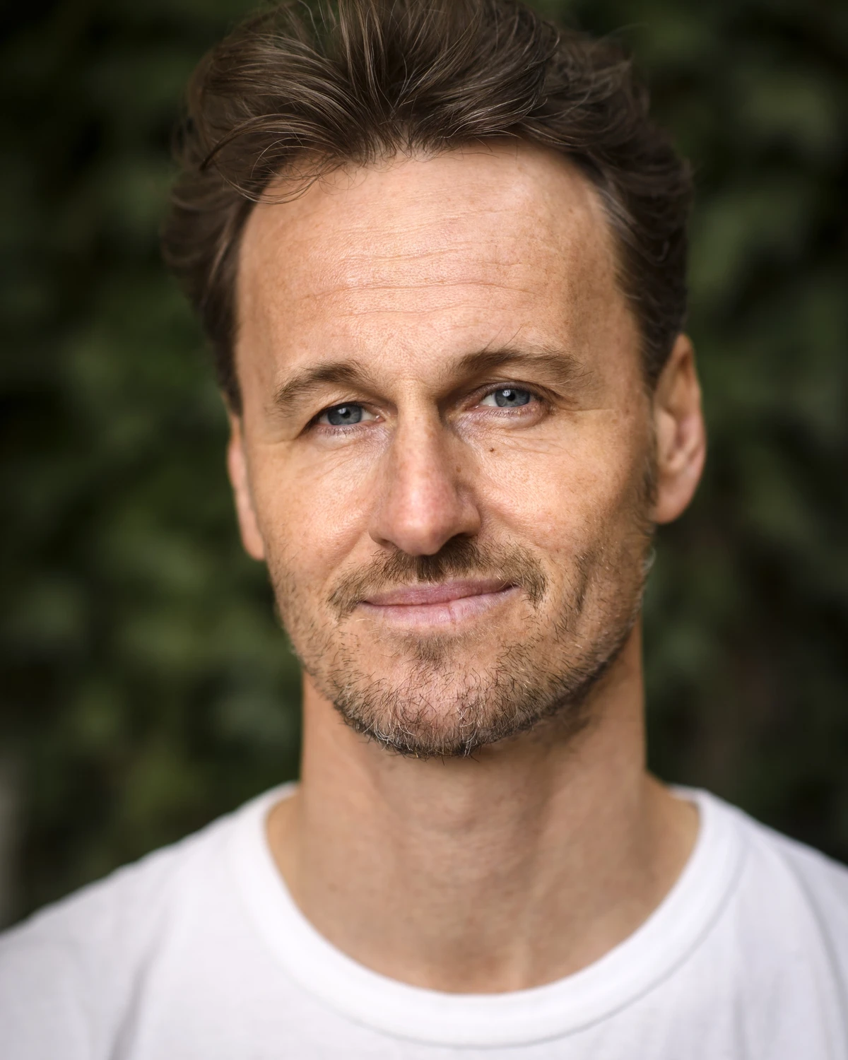 Yogaläraren och författaren Magnus Fridh i vit t-shirt