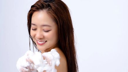 Asian woman happily taking a shower.