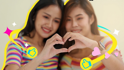 LGBT lesbian couple making a heart sign with hands