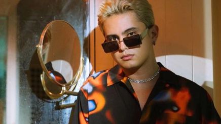 A portrait of James Reid with bleached hair wearing sunglasses and oversized shirt.