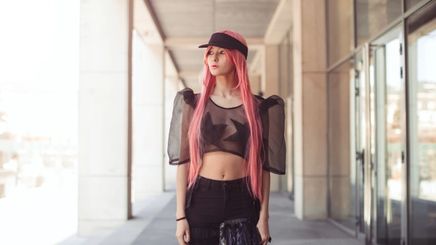 An Asian woman with extra-long pink hair