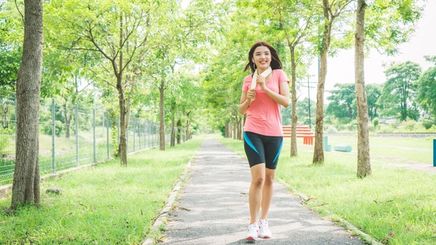 A woman jogging outdoors in the morning.