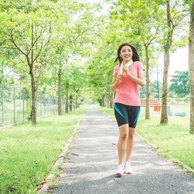 A woman jogging outdoors in the morning.