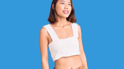 An Asian woman wearing a sleeveless cropped top