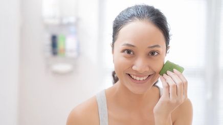 Woman applying anti-acne product