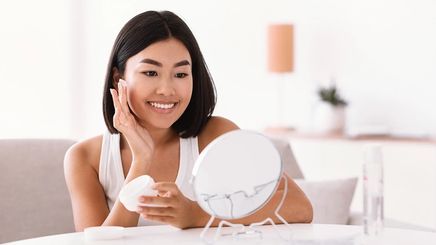 Asian woman doing skincare routine