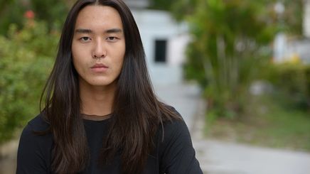 Asian man with long hair