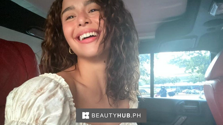 Filipino actress Yassi Pressman with curly hair taking a selfie in a car.