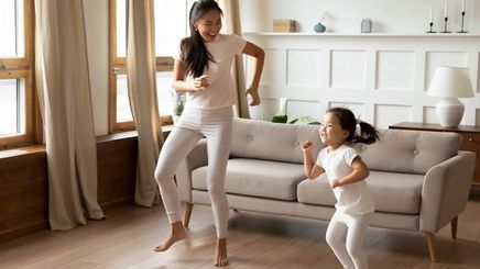 A woman and child dancing at home