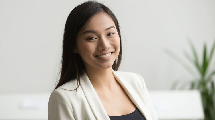 Asian woman with long hair in office wear