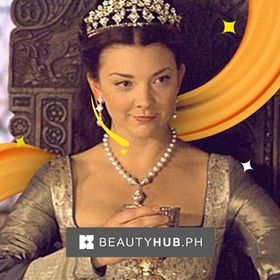 Anne Boleyn in The Tudors wearing crown and sitting on a throne.  