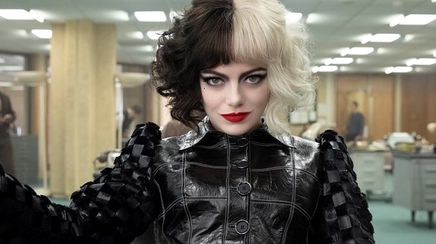 Emma Stone as Cruella wearing black and white wig