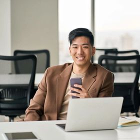 Confident young Asian man at the office.