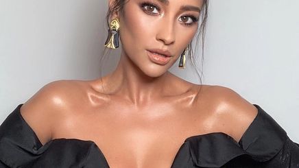 A portrait of Shay Mitchell with dewy, dolphin skin.