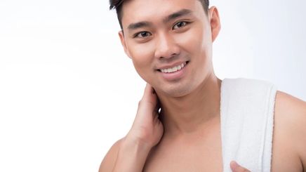 Asian man with towel on shoulder 