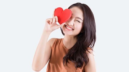 Asian woman holding heart
