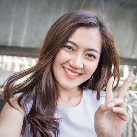 Woman with long hair taking a selfie while making a peace sign. 