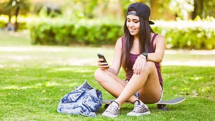 Girl wearing shorts sitting on grass