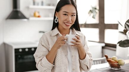Asian woman having a cup of coffee