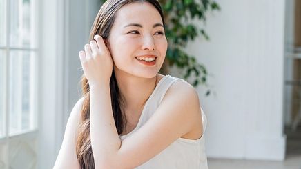 Asian woman with bright glowing skin at home
