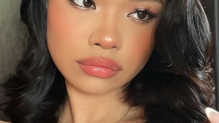 A woman with morena skin wearing Douyin makeup.