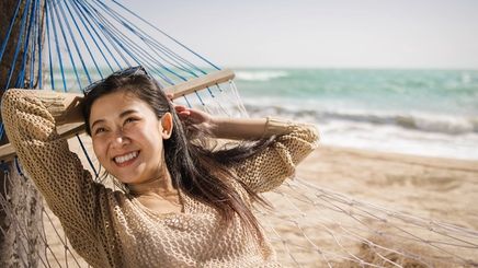 Asian woman happy at the beach