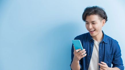 Man laughing holding a phone.