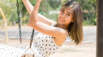 Asian woman outdoors in a polka dot dress
