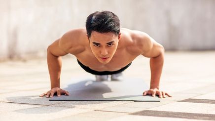 Asian man doing push ups