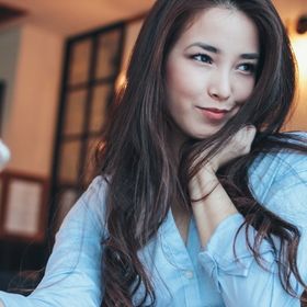 Asian woman with long hair pouting for a selfie.